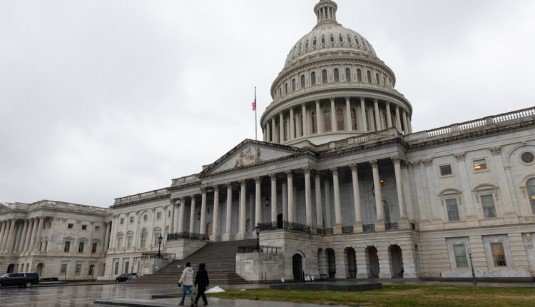 Pedestrians are seen walking in front of the U.S. Capitol in Washington.