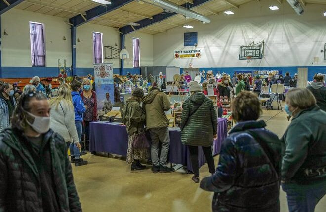 Vendors are set up in the gym, hallway, and rooms as part of the South Lansing Farmers Market Saturday, Feb. 5, 2022 at the former St. Casimir School on Barnes Avenue. 