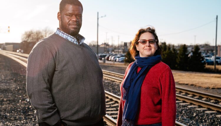 Former Transit Riders United (TRU) board President Donald Stuckey and TRU Executive Director Megan Owens stand by the Amtrak line in Dearborn.