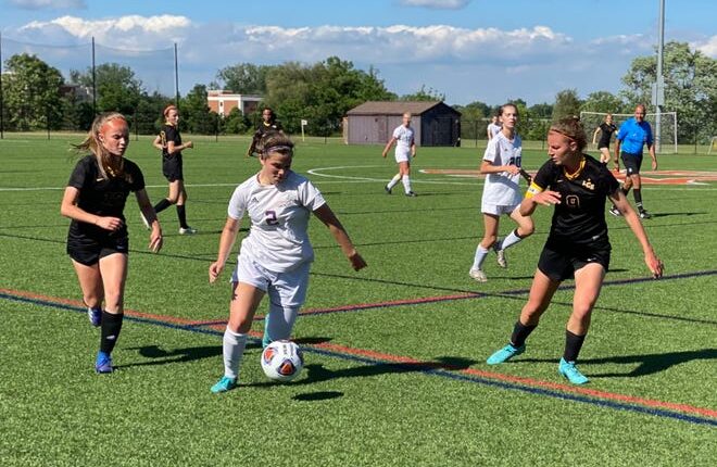 Lansing Christian's Mia Judd, right, defends against a Kalamazoo Christian attack during a Division 4 regional semifinal at Portage Northern on Tuesday, June 7, 2022.