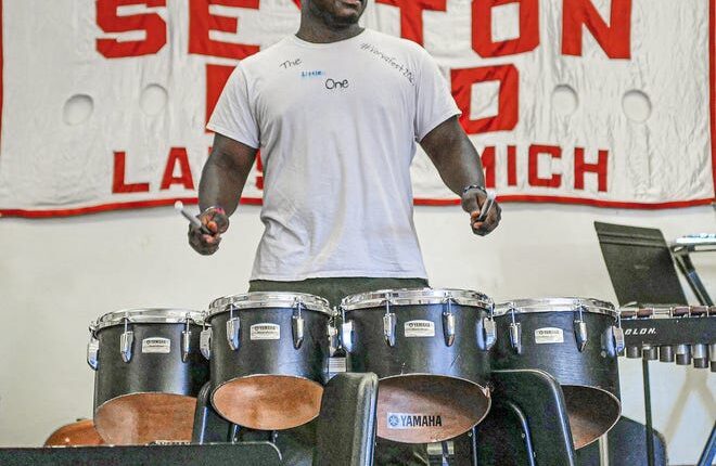 Dayveon Thomas, recent Sexton graduate, practices with the drumline for the Juneteenth parade Friday, June 17, 2022. He plans to become a firefighter once he gets certified.