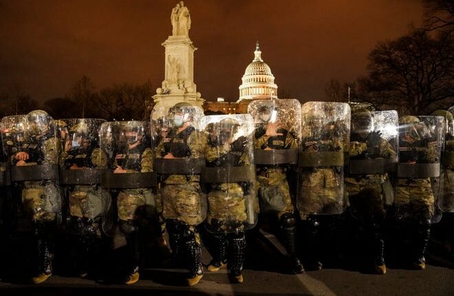 District of Columbia National Guardsmen stand outside the Capitol on Jan. 6, 2021, after a day of rioting protesters.