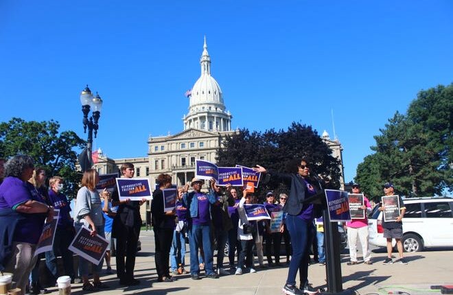 Shanay Watson Whittaker leads the small crowd in applause at Reproductive Freedom for All's rally on Wednesday, Sept. 7, 2022, at Lansing City Hall.