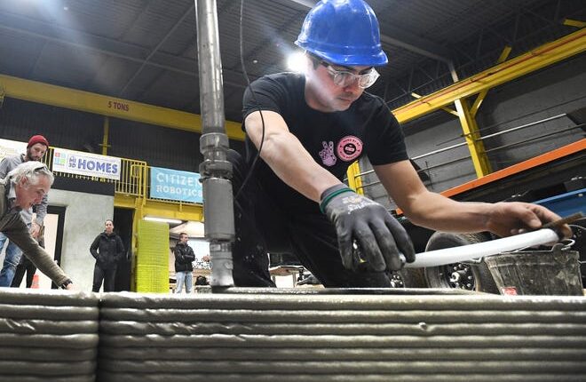 Fernando Bales of Citizen Robots watches over the 3D print of an eventual 52