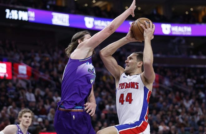 Pistons forward Bojan Bogdanovic drives to the basket against Jazz forward Kelly Olynyk in the first half on Wednesday, Nov. 23, 2022, in Salt Lake City.
