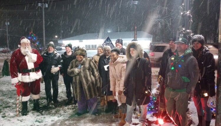 Santa Claus and Lansing residents gathered in the snow to sing carols and light the holiday lights in the Plaza located at the corner of Pleasant Grove Rd. and Holmes Rd. in southwest Lansing. The event was sponsored by Southwest Lansing Action Group (SWAG).