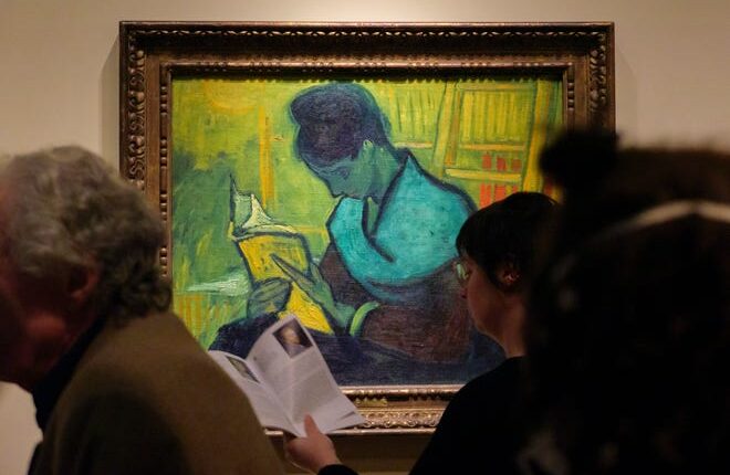 Visitors file past at the Van Gogh painting 