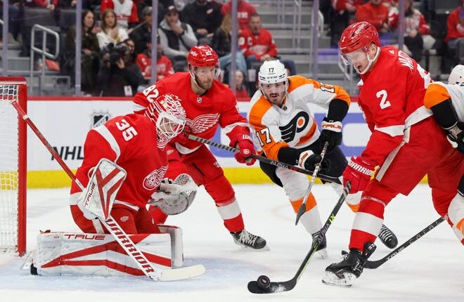 Detroit Red Wings defenseman Olli Maatta (2) clears the puck from in front of goaltender Ville Husso (35) in the first period at Little Caesars Arena in Detroit on Saturday, Jan. 21, 2023.